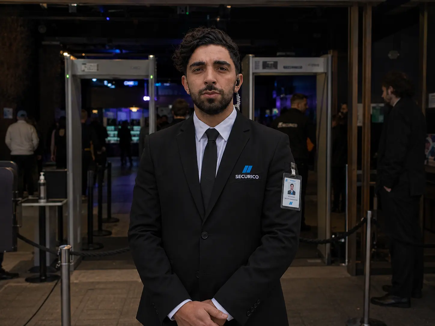 SIA door supervisor managing access at a busy public-facing venue